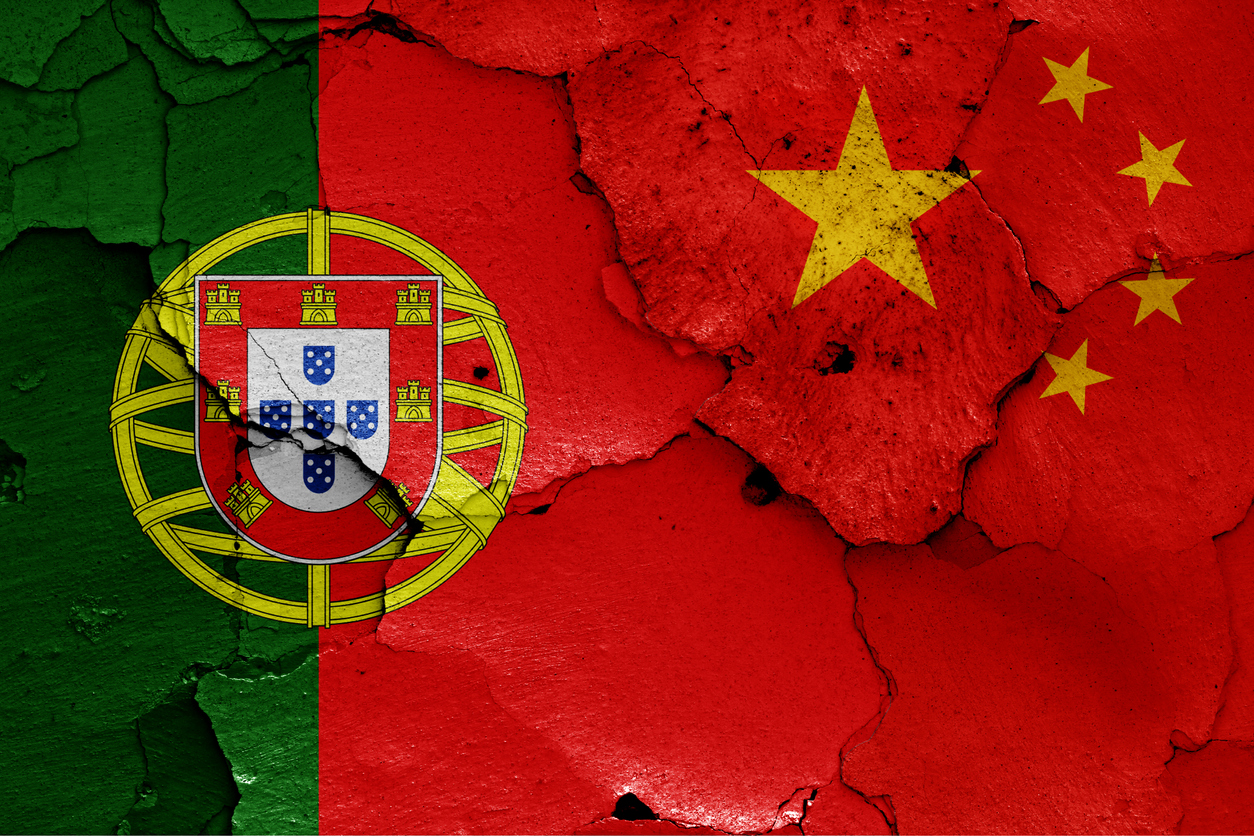 Flags Of Portugal And China Painted On Cracked Wall